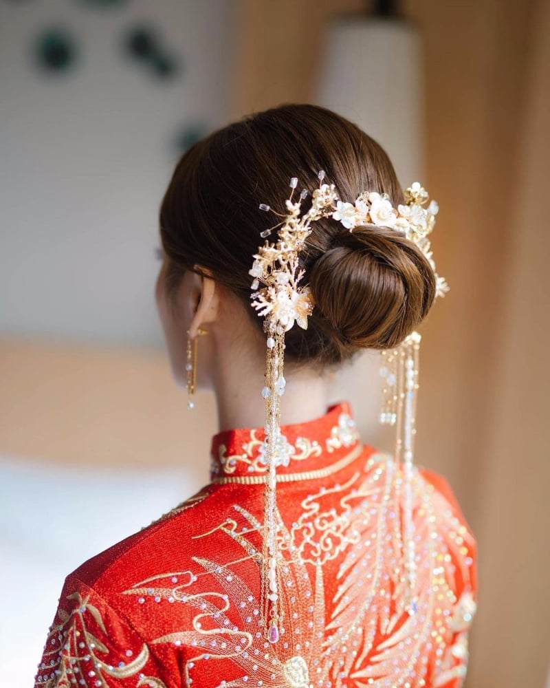 Sleek Low Bun With Floral Accessories Sleek Low Bun With Floral Accessories — Chinese Wedding Hairstyles 2027