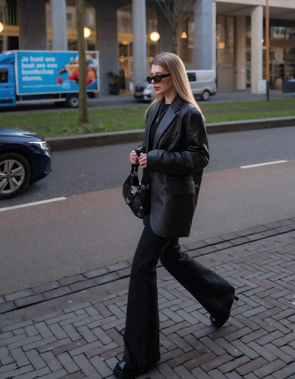 Dark wash flare jeans with an oversized leather blazer — Concert Bootcut Jeans Outfits 2027
