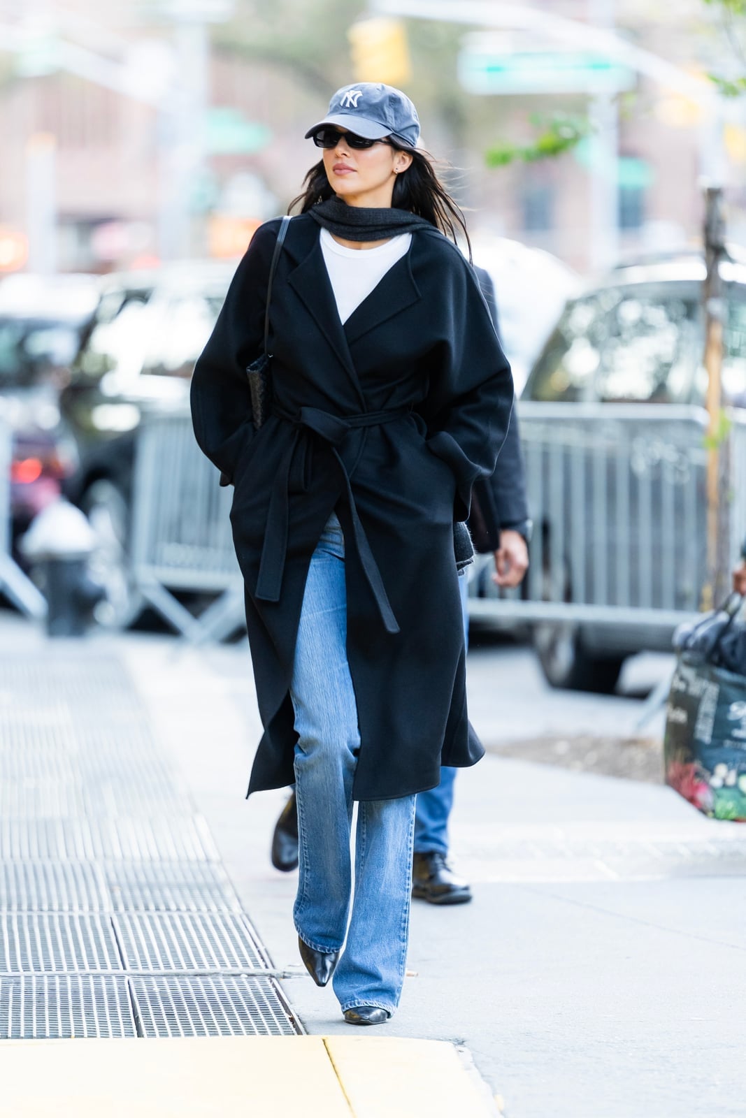 Blue bootcut jeans with a white tee, scarf, and tie-waist coat — Concert Bootcut Jeans Outfits 2027