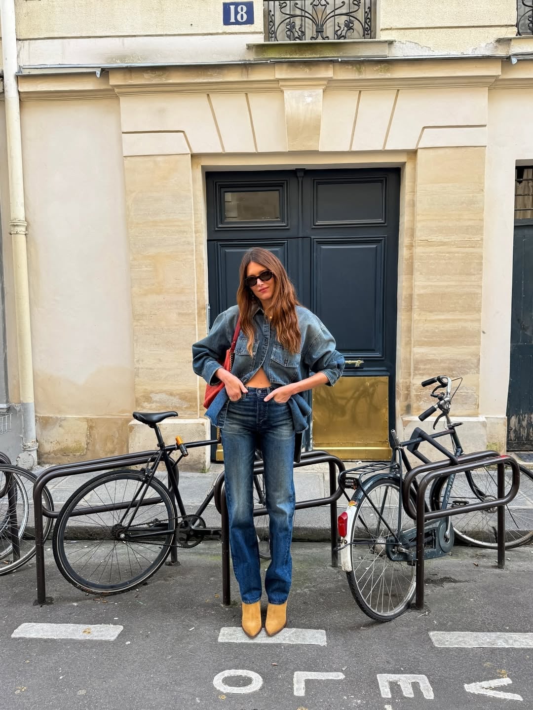 Dark wash bootcut jeans with a black crop top and denim shirt — Concert Bootcut Jeans Outfits 2027