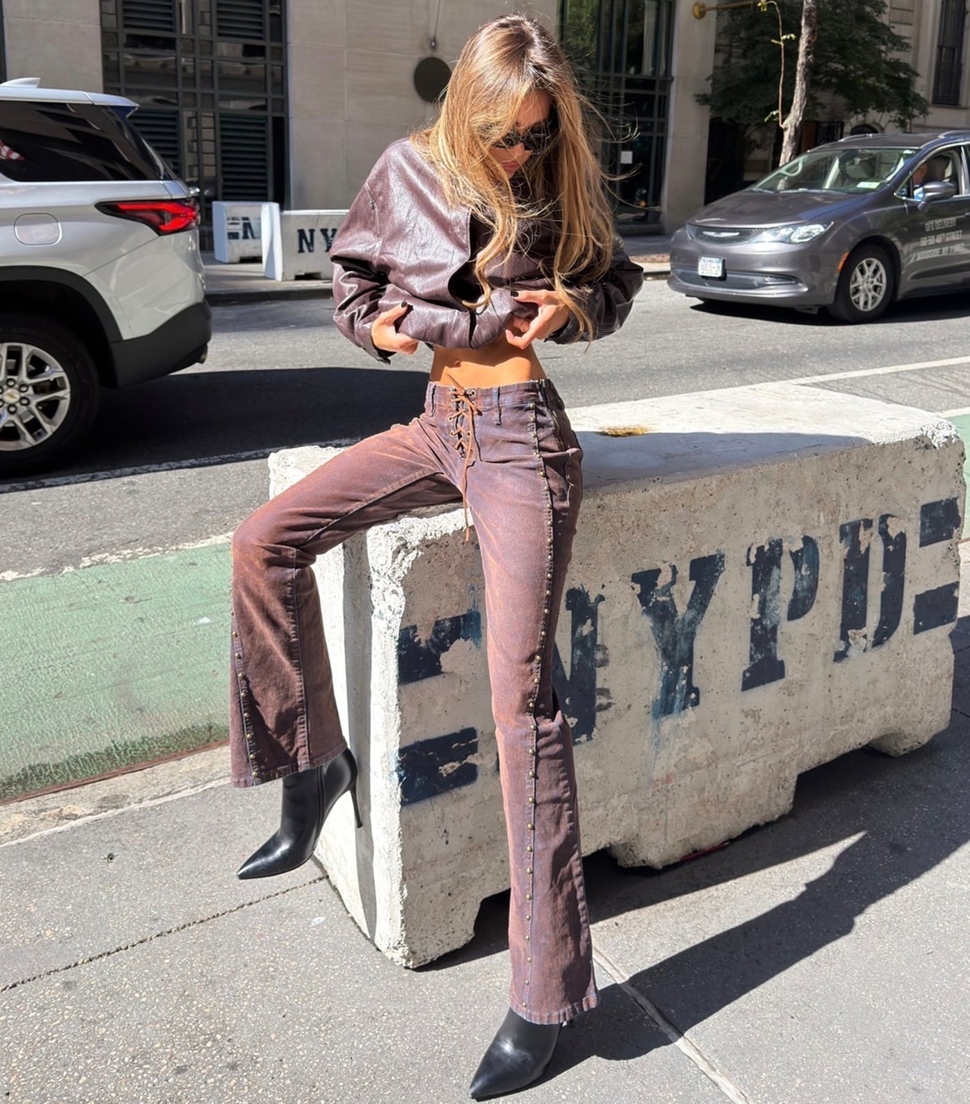 Brown bootcut jeans with a lace-up front and leather jacket — Concert Bootcut Jeans Outfits 2027