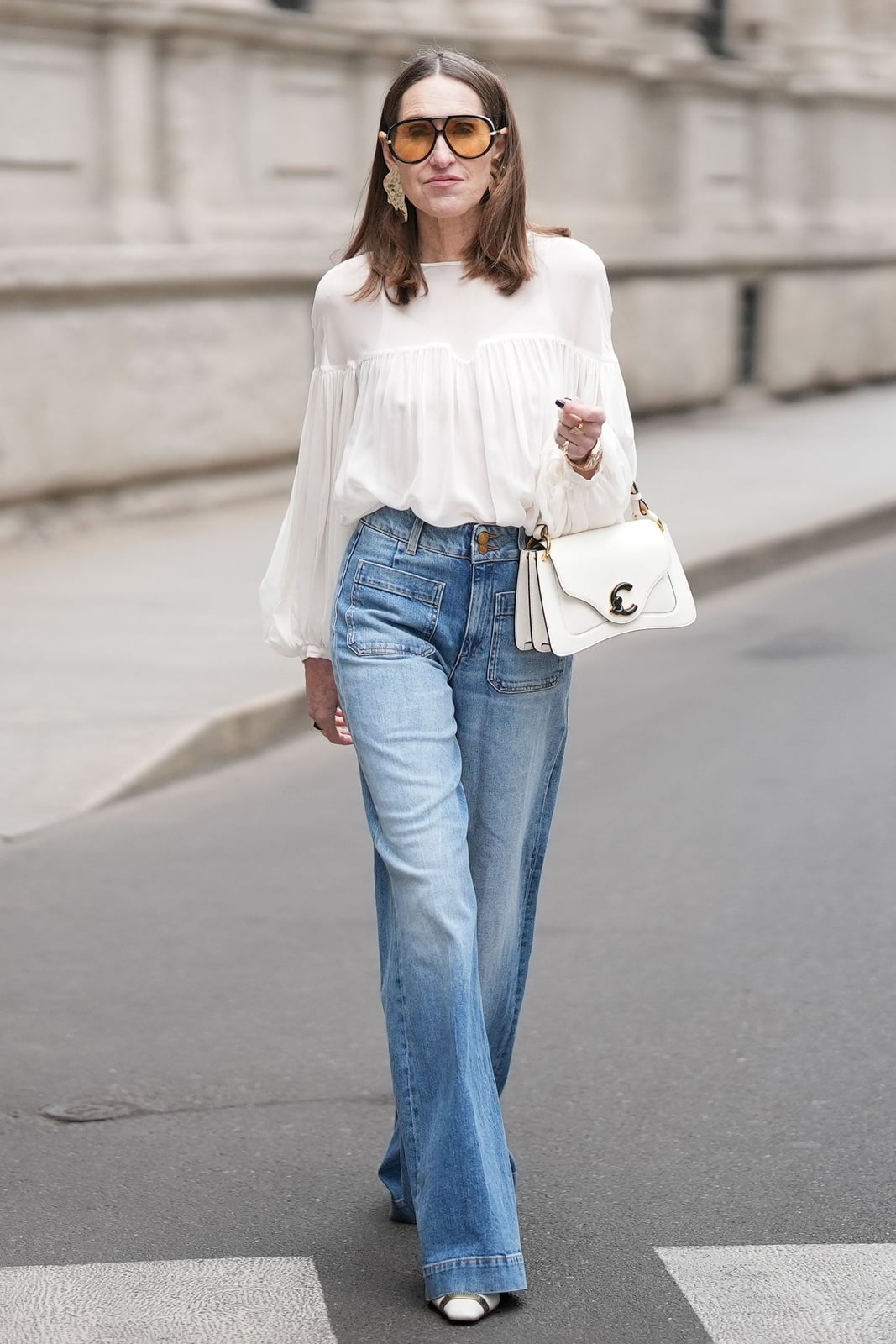 Blue bootcut jeans with a voluminous white sleeve blouse — Concert Bootcut Jeans Outfits 2027