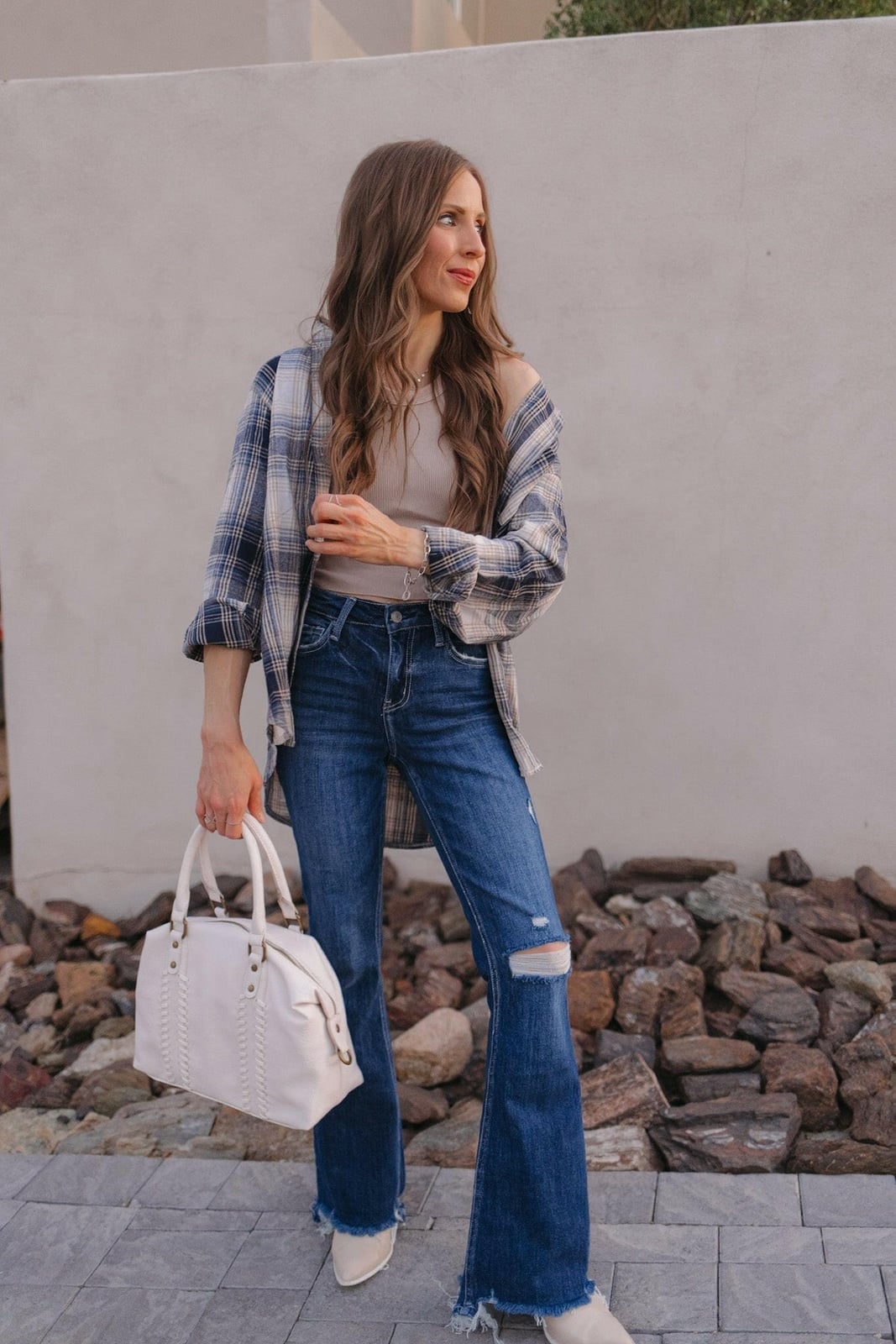 Distressed blue bootcut jeans with plaid shirt and white boots — Concert Bootcut Jeans Outfits 2027