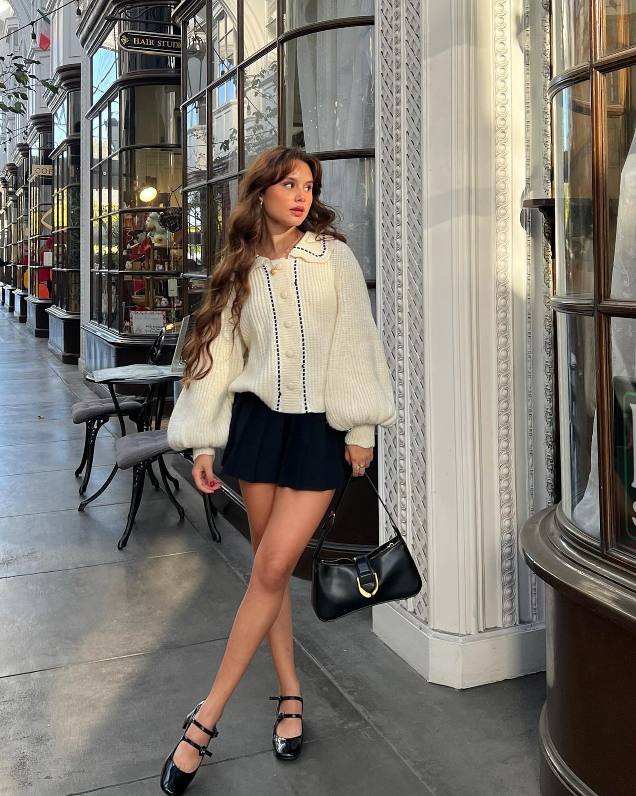 Cream oversized cardigan with navy mini skirt, Black Shoulder Bag — Coquette Spring Outfits 2027