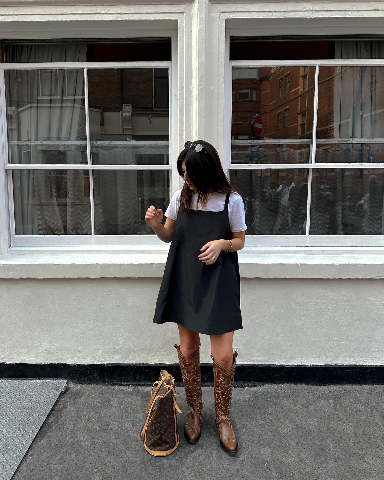 Brown cowboy boots with a black pinafore dress and white t-shirt Brown cowboy boots with a black pinafore dress and white t-shirt — Cowboy Boots Outfits 2027 with Sundress