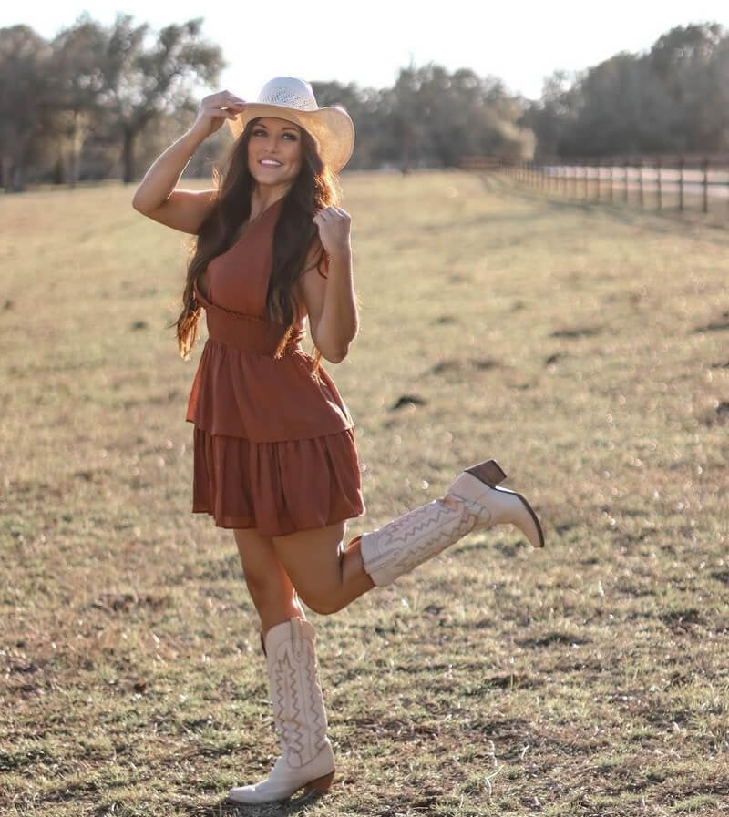 Cream cowboy boots with a rust tiered mini dress and straw hat Cream cowboy boots with a rust tiered mini dress and straw hat — Cowboy Boots Outfits 2027 with Sundress