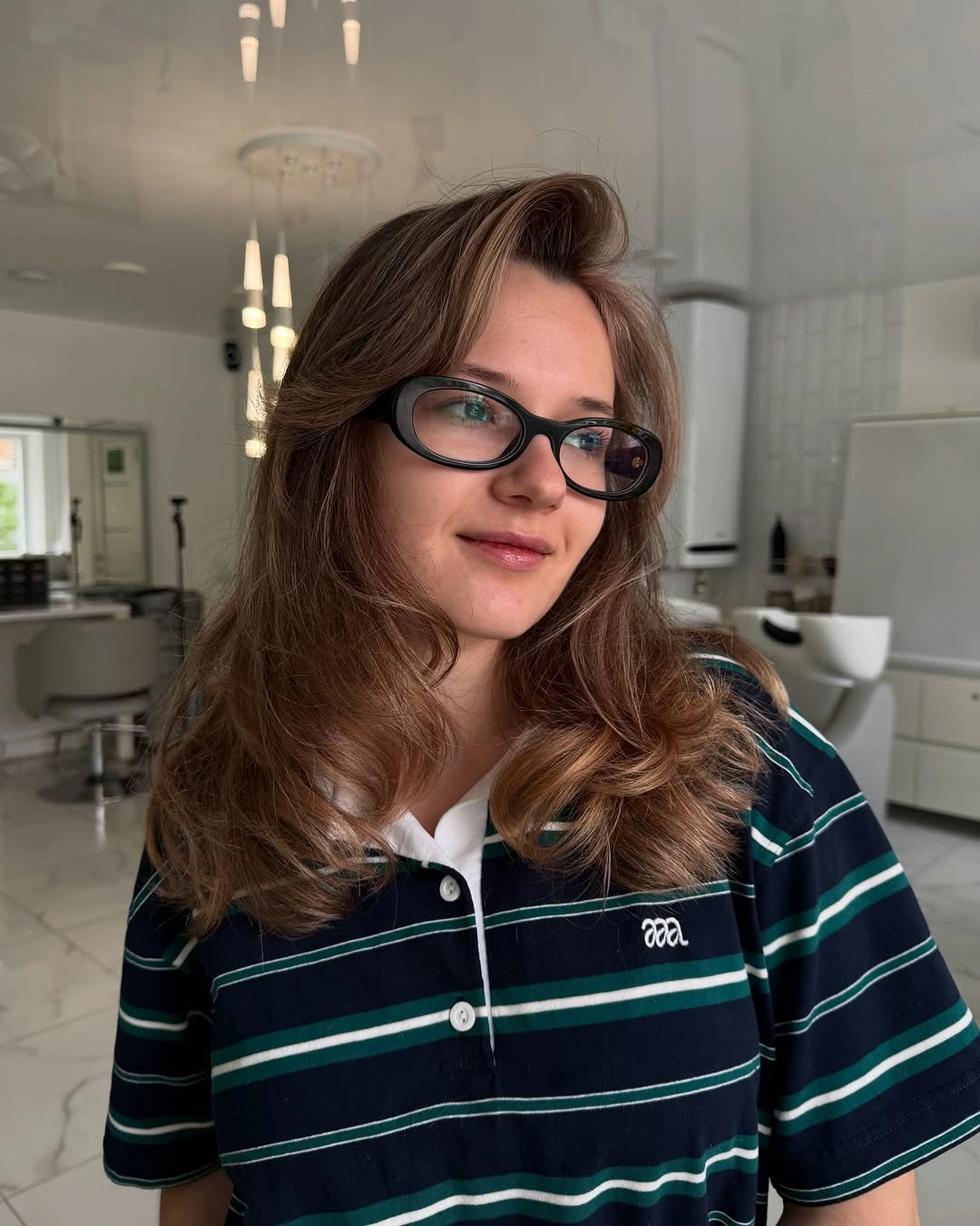 A Side Part Shifts the Layered Balance Warm brown layered hair with side part and broad curved ends