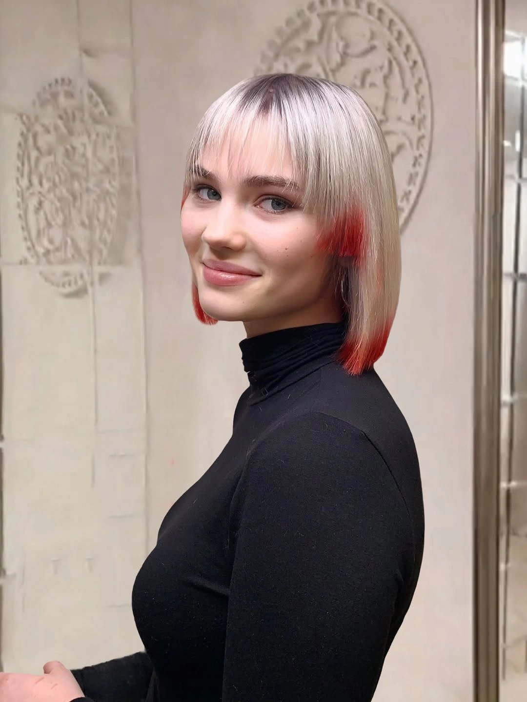 A Graphic Bob With Red Edge Accents Pale silver-blonde bob with straight fringe and vivid red accents