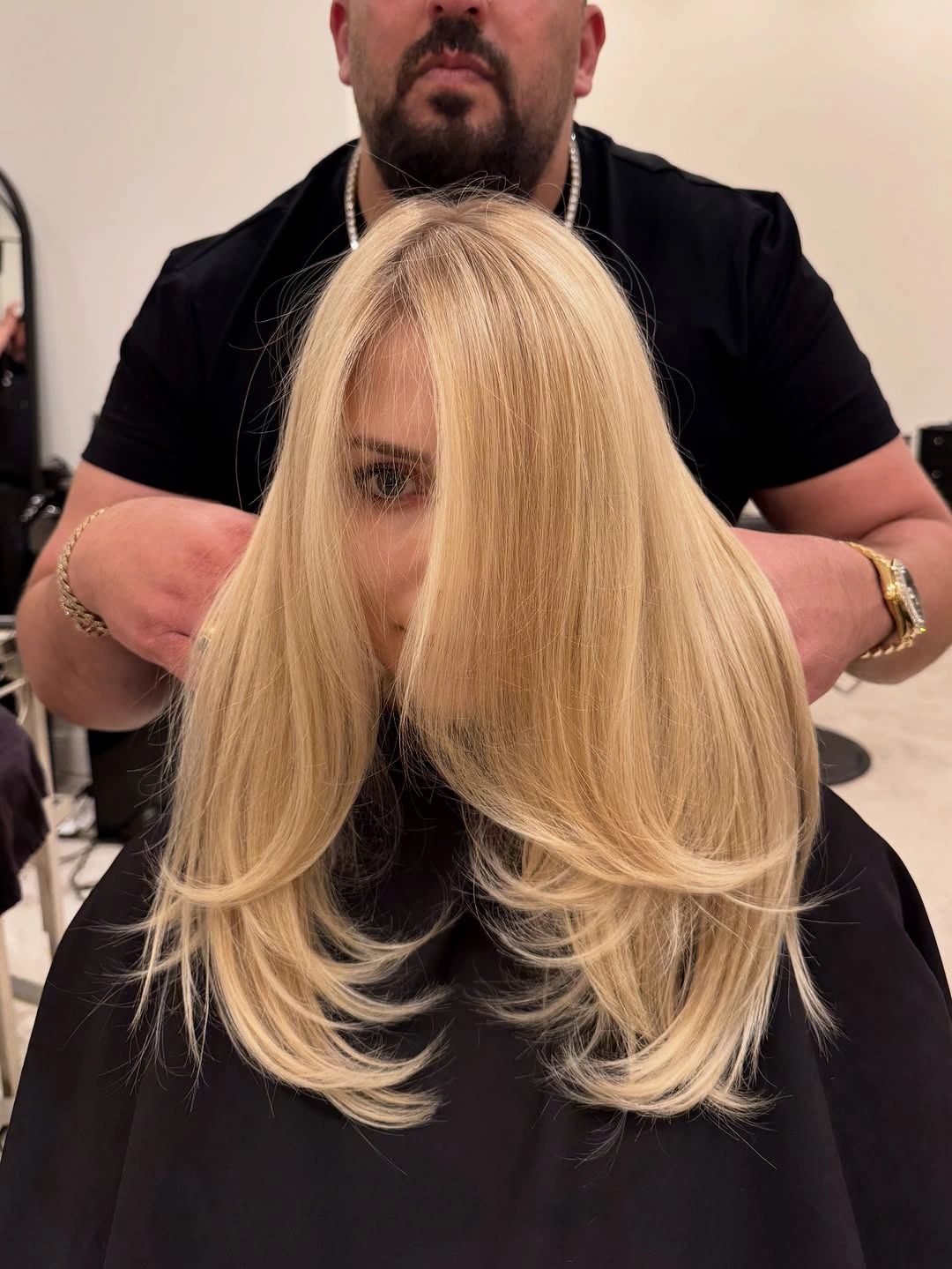 Long Blonde Layers With a Feathered Lower Shape Long blonde hair with face-framing pieces and outward-curving layers
