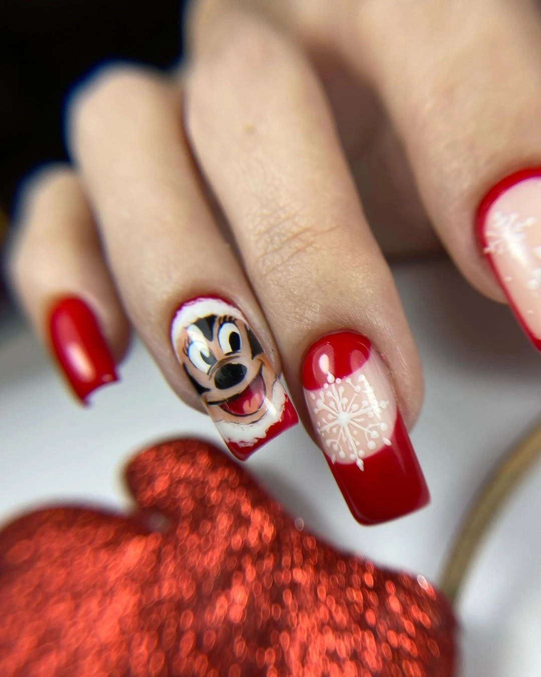Glossy Red Christmas Nails With Character Art Long red square nails with cartoon portrait and snowflake accents