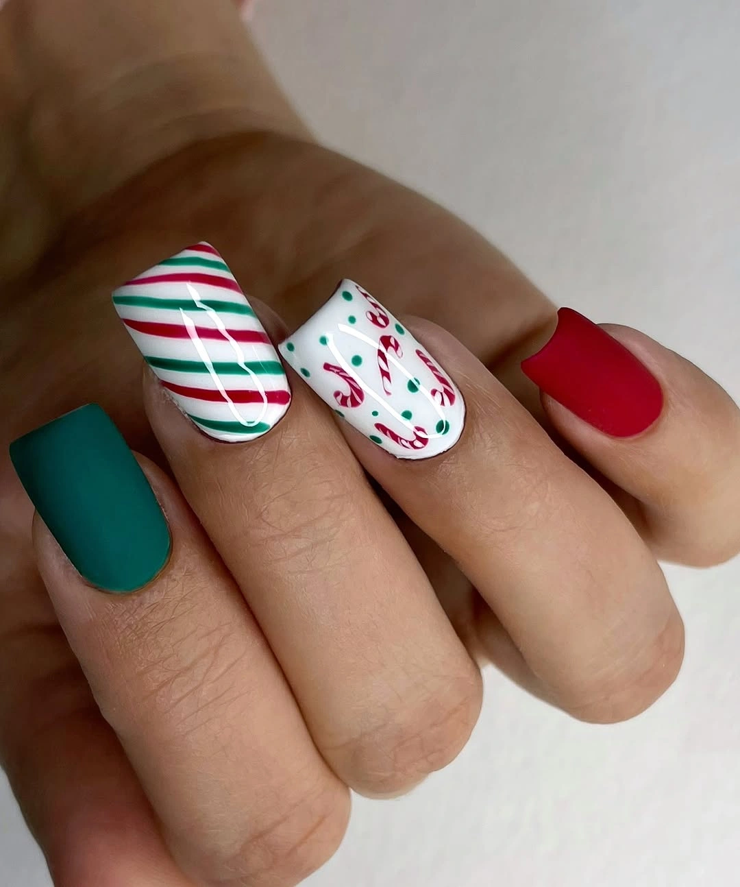 Red and Green Candy Cane Christmas Nails Square red and green nails with stripes and candy cane art