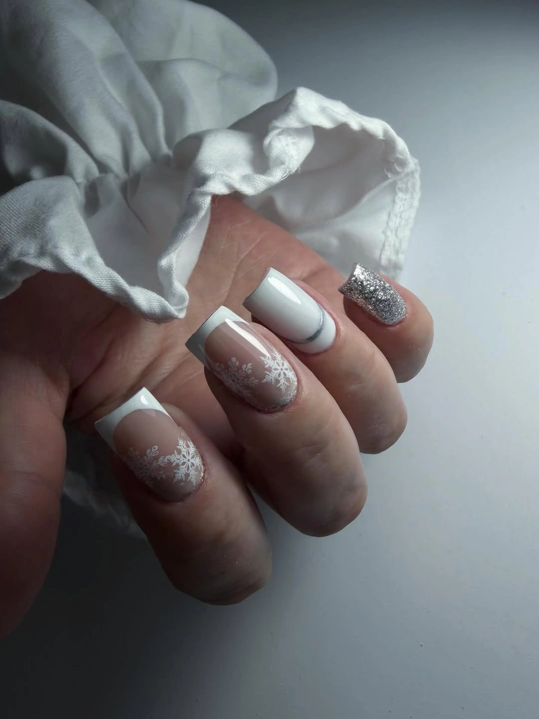 Icy Square Nails With Snowflakes and Silver Sparkle Square white and nude nails with snowflakes and silver glitter