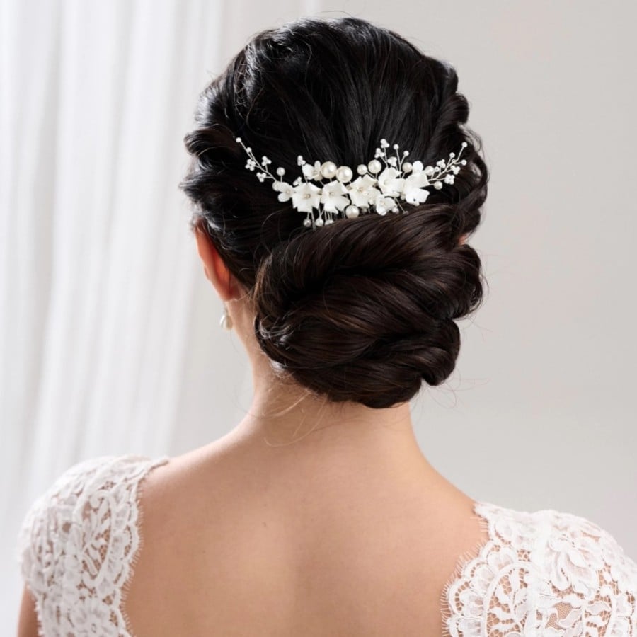 Dark Brown Chignon With Floral Accessory Dark Brown Chignon With Floral Accessory — Destination Wedding Hairstyles 2027