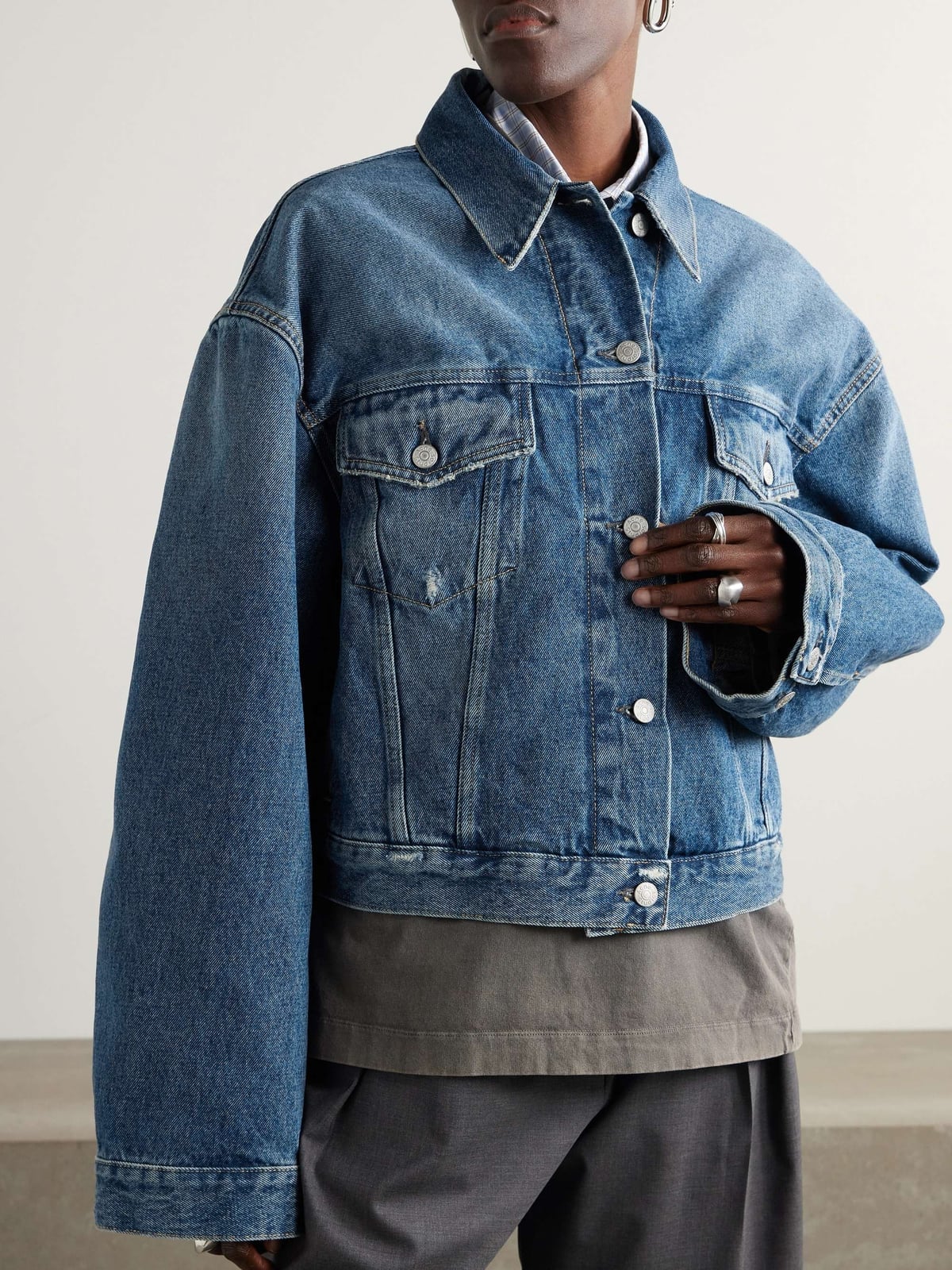 Oversized Medium Blue Denim Jacket With Gray Trousers, Close-Up Take Oversized Medium Blue Denim Jacket With Gray Trousers, Close-Up Take — Distressed Denim Jacket Outfits 2027