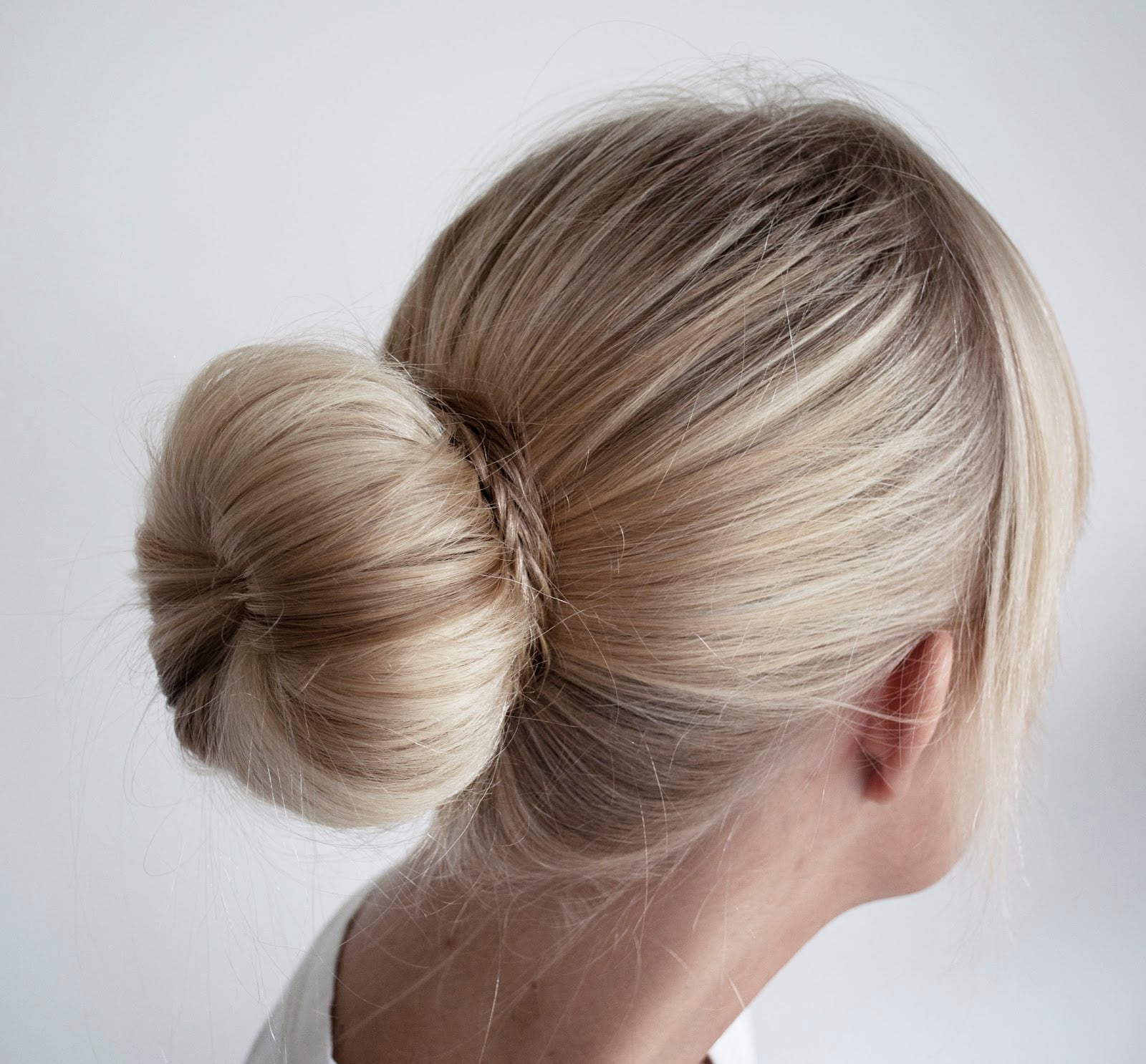 Fine Ash Blonde Low Bun With Braid Accent Fine Ash Blonde Low Bun With Braid Accent — Donut Bun Hairstyles 2027