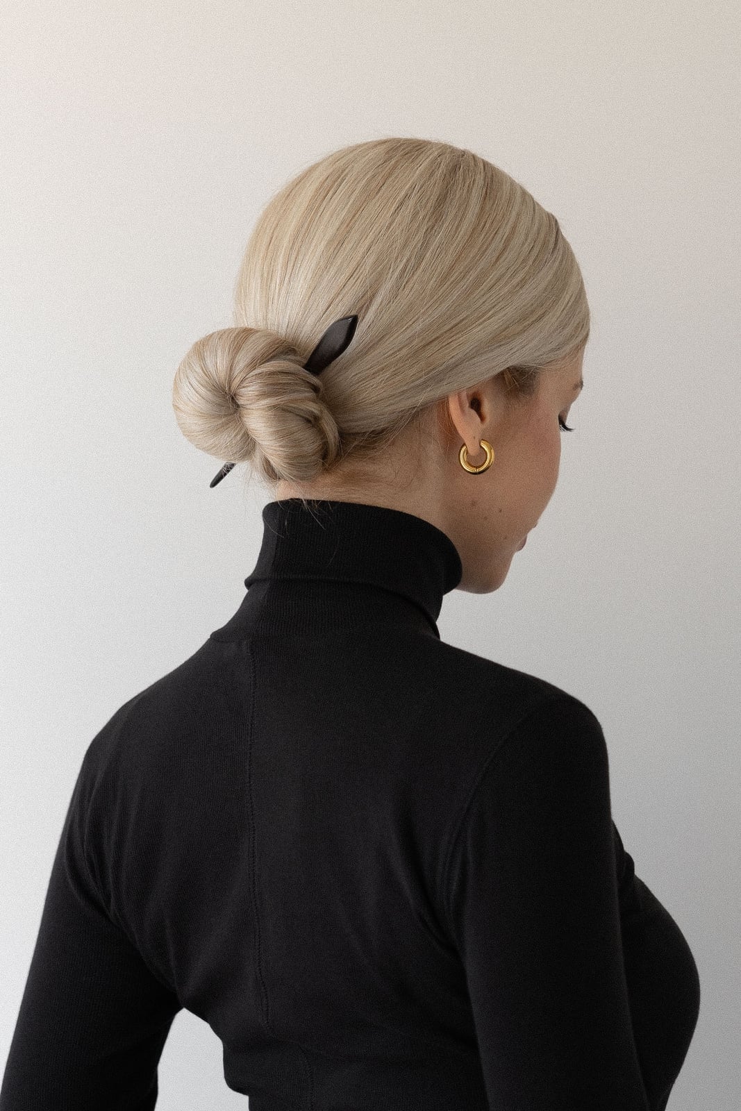 Blonde Low Bun With Hair Stick Detail Blonde Low Bun With Hair Stick Detail — Donut Bun Hairstyles 2027