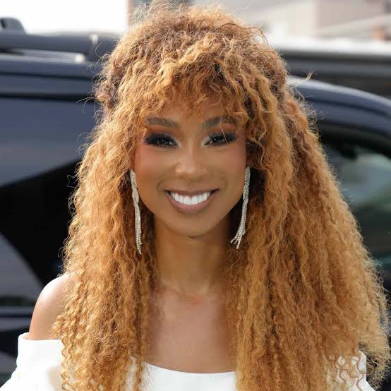 Honey Blonde Air Dried Curls With Curly Bangs Honey Blonde Air Dried Curls With Curly Bangs — Down Country Concert Hairstyles 2027