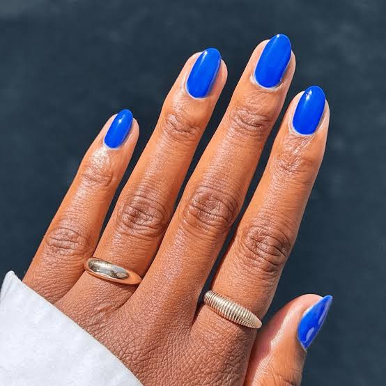 Vibrant Glossy Electric Blue Short Oval Nails, Close-Up Take Vibrant Glossy Electric Blue Short Oval Nails, Close-Up Take — Electric Blue Nails 2027