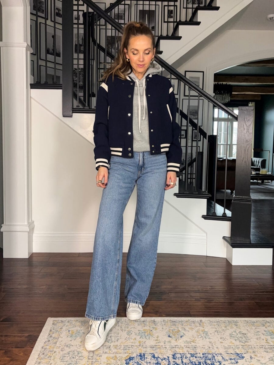 Navy varsity bomber jacket with light wash wide-leg jeans, Gray Hoodie Navy varsity bomber jacket with light wash wide-leg jeans, Gray Hoodie — Fall Bomber Jacket Outfits 2026