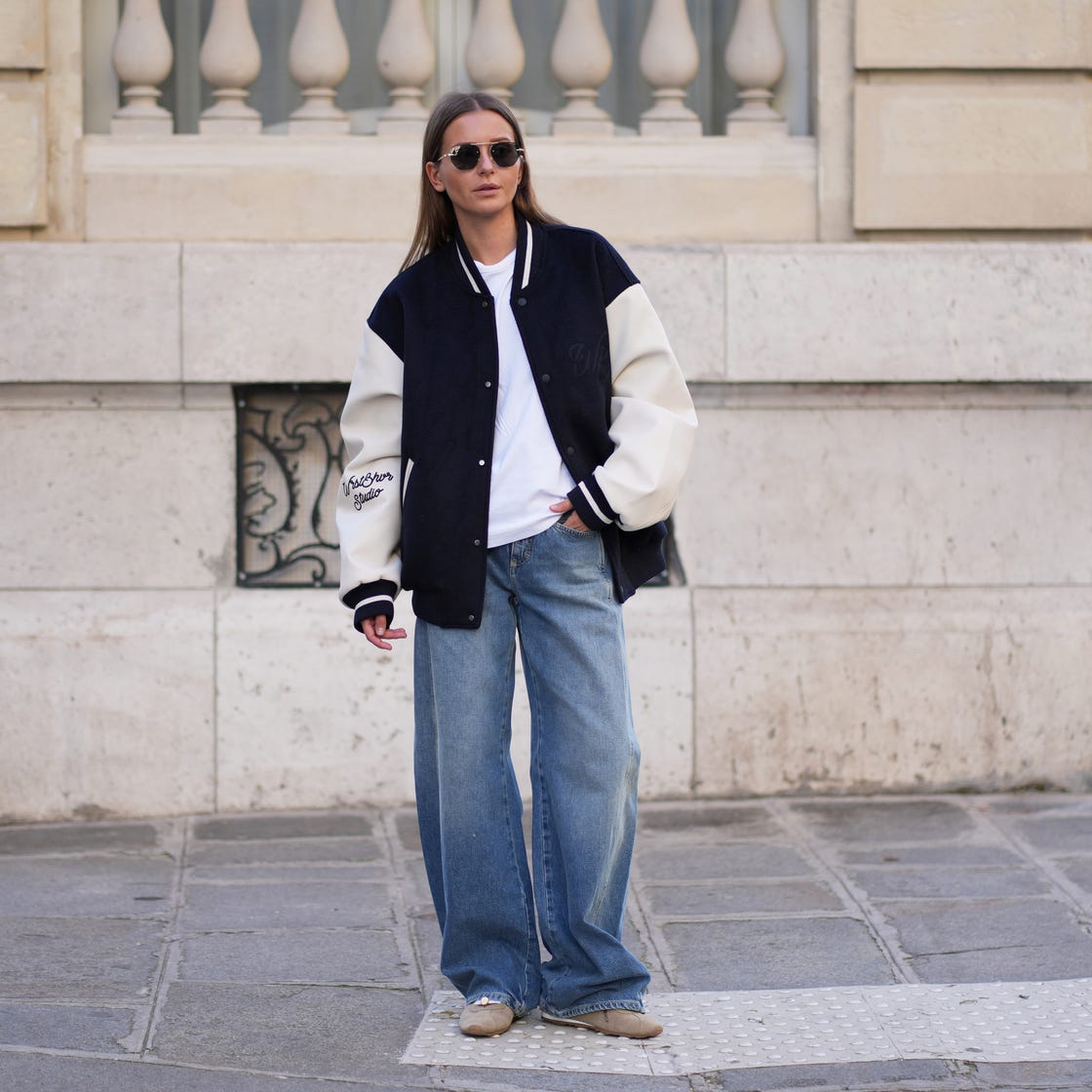 Navy and white varsity bomber jacket with wide-leg jeans Navy and white varsity bomber jacket with wide-leg jeans — Fall Bomber Jacket Outfits 2026