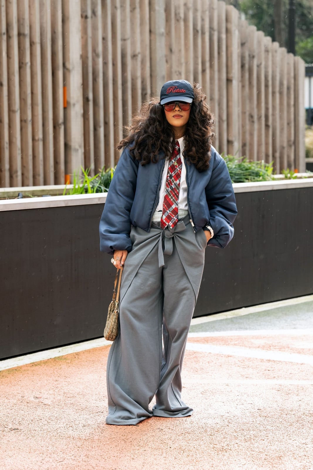 Navy oversized bomber jacket with gray wide-leg pants Navy oversized bomber jacket with gray wide-leg pants — Fall Bomber Jacket Outfits 2026