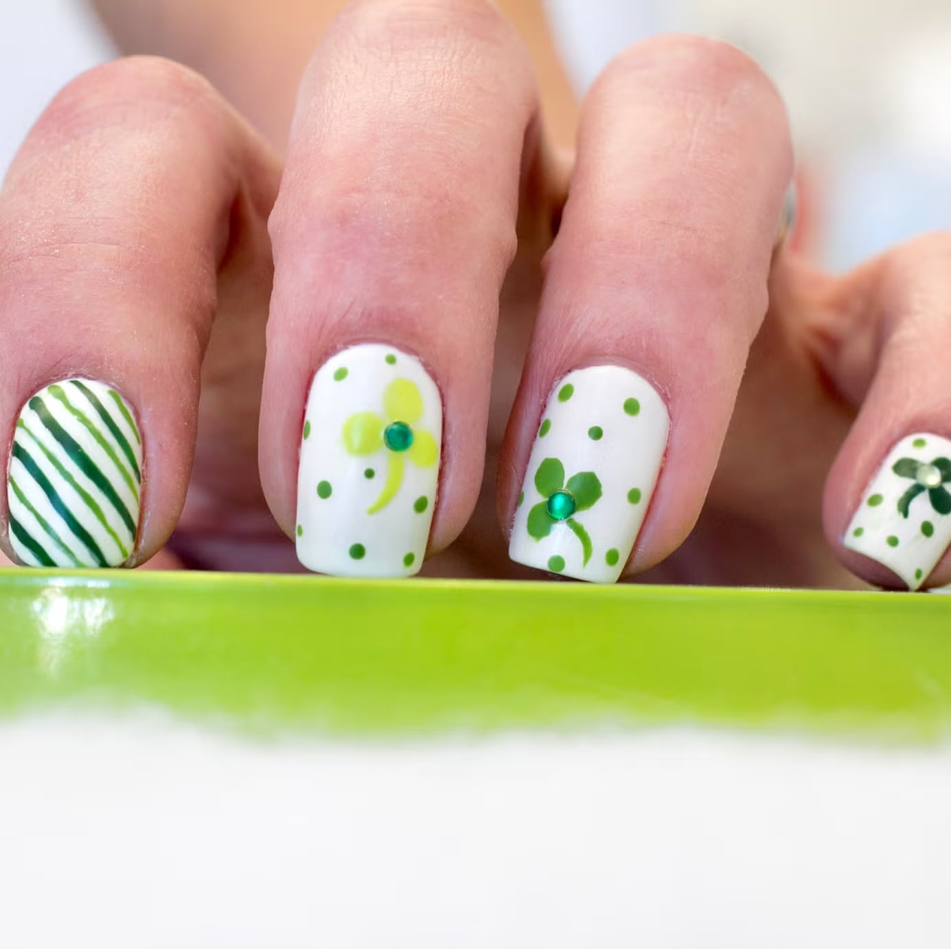 Short Square White With Green Clovers And Rhinestones, Close-Up Take Short Square White With Green Clovers And Rhinestones, Close-Up Take — Four Leaf Clover Nails 2027
