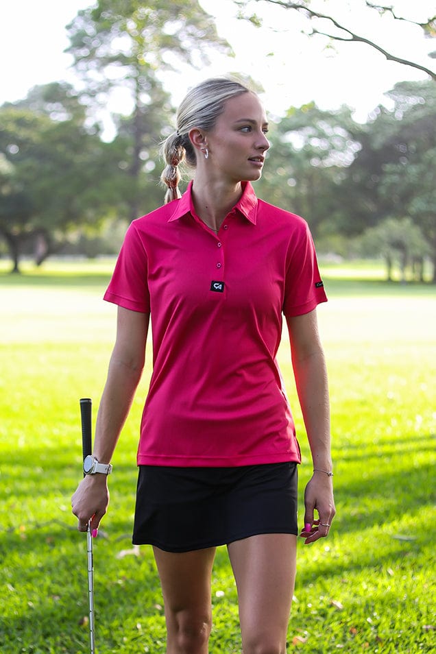 Bright pink polo with black skort, Close-Up Take Bright pink polo with black skort, Close-Up Take — Golf Tournament Outfits 2027