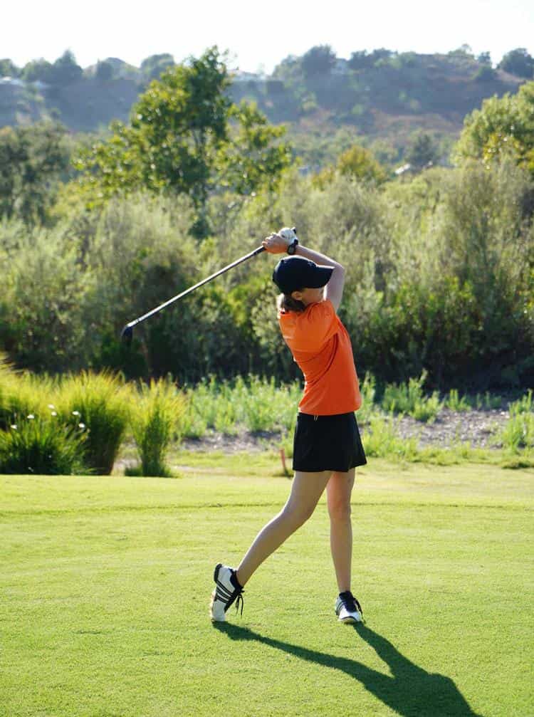Bright orange golf shirt with black skort Bright orange golf shirt with black skort — Golf Tournament Outfits 2027