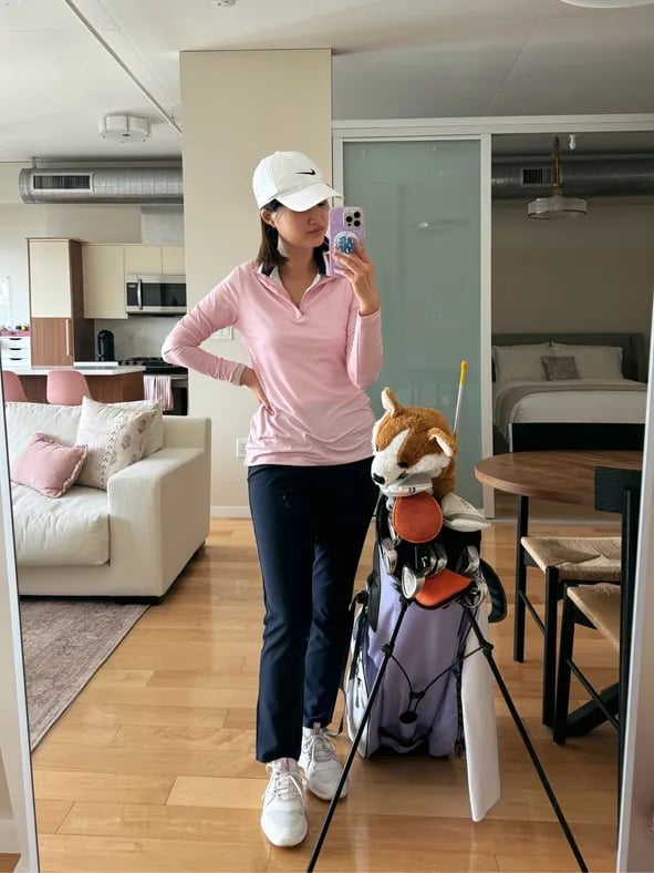 Pink quarter-zip shirt with navy athletic pants Pink quarter-zip shirt with navy athletic pants — Golf Tournament Outfits 2027