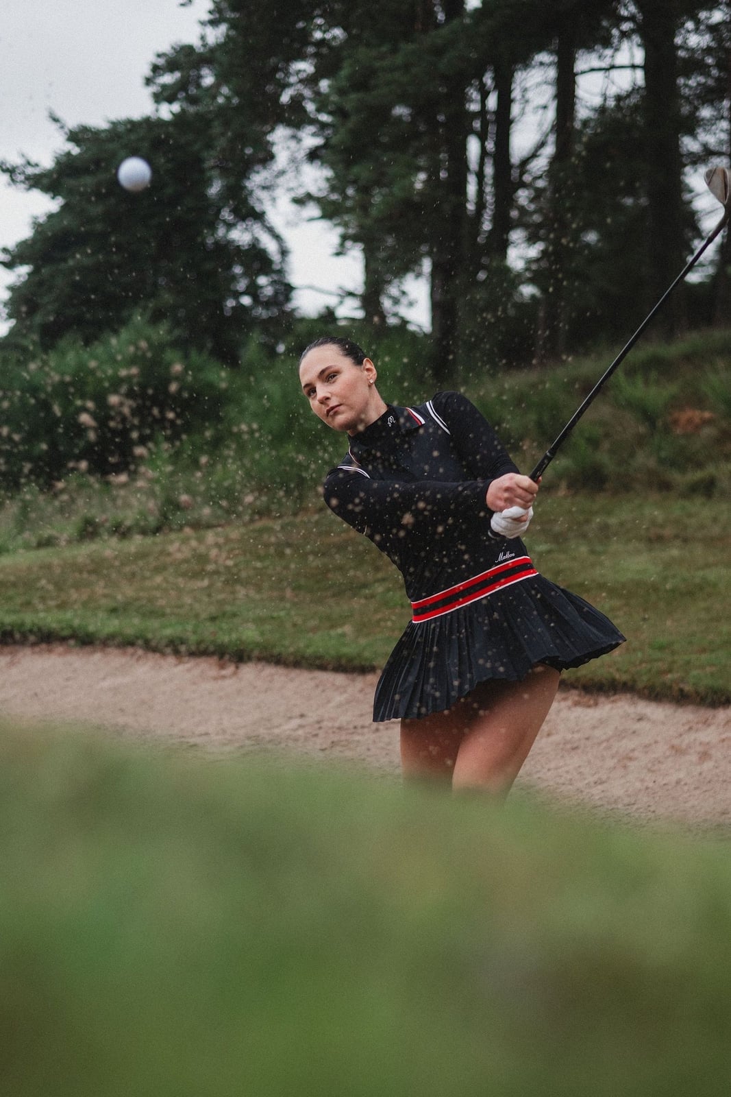 Black pleated mini skirt with long-sleeve golf, Office-Safe Version Black pleated mini skirt with long-sleeve golf, Office-Safe Version — Golf Tournament Outfits 2027