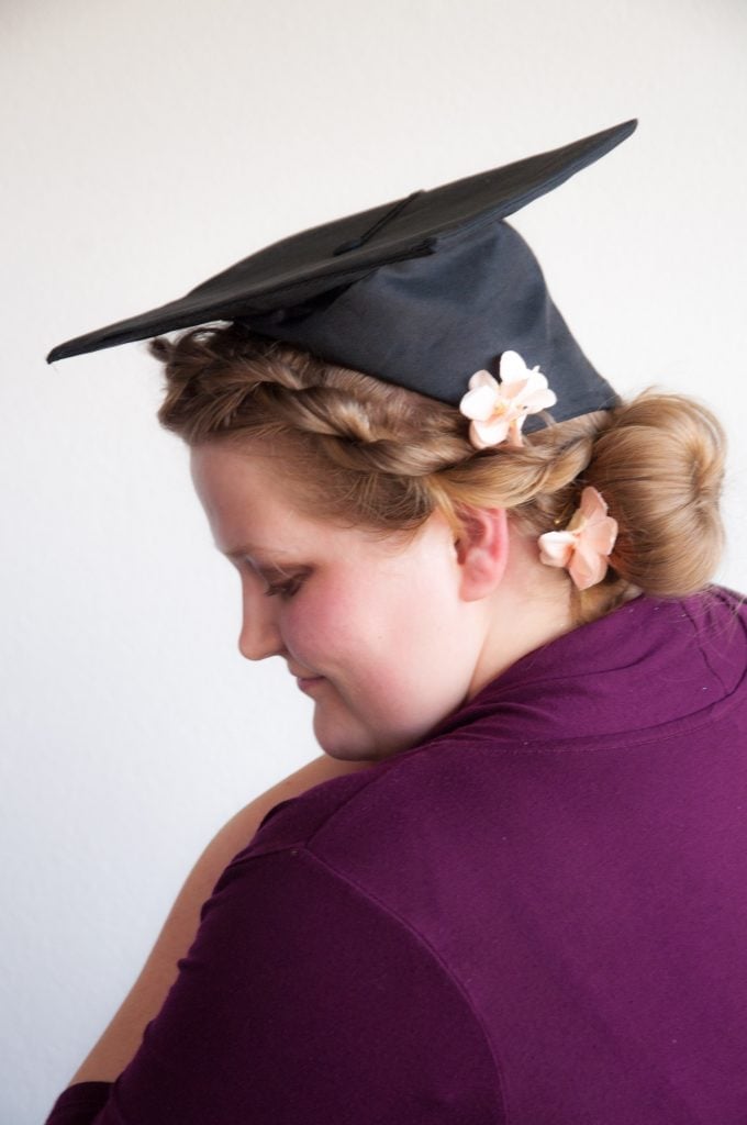 Light Brown Braided Updo With Flowers Light Brown Braided Updo With Flowers — Graduation Hairstyles 2027 with Cap
