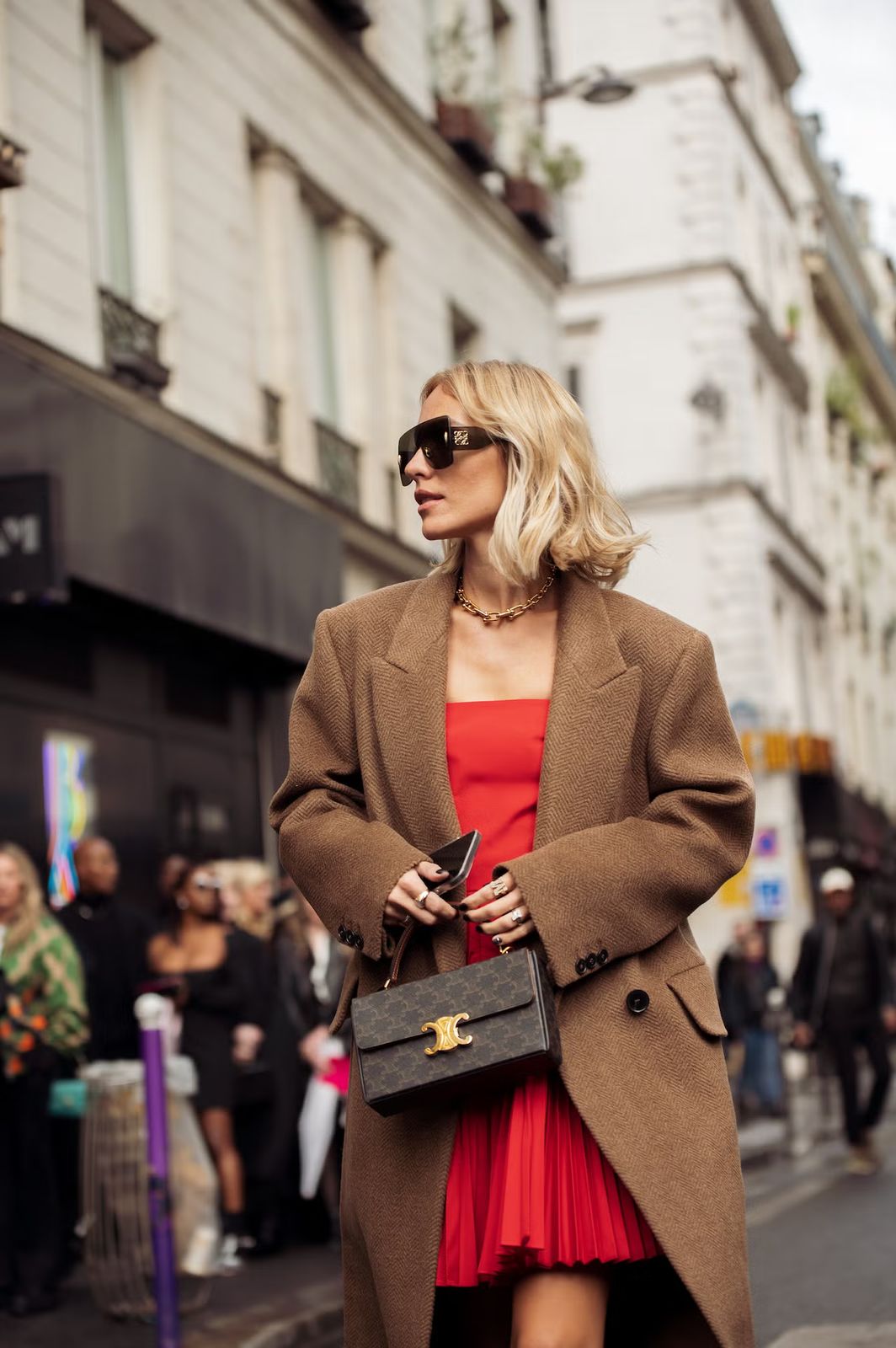 Sophisticated Layering: Brown Coat Over a Red Pleated Dress Sophisticated Layering: Brown Coat Over a Red Pleated Dress — Red Outfits 2027