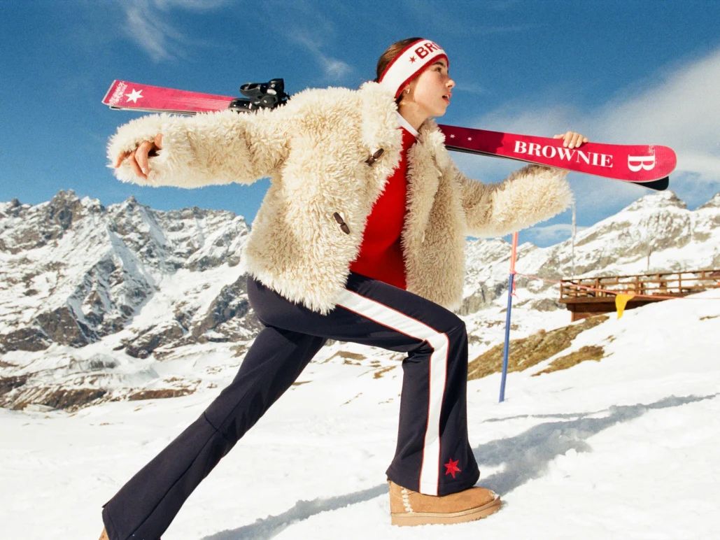 Cream Fuzzy Jacket Over Red Sweater and Navy Flared Pants Cream Fuzzy Jacket Over Red Sweater and Navy Flared Pants — Ski Outfits for Women 2027