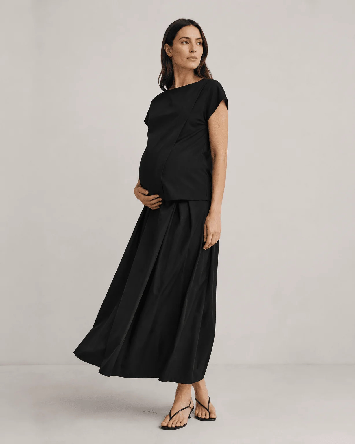 Monochromatic Maternity: Black Top and Pleated Skirt Combination Monochromatic Maternity: Black Top and Pleated Skirt Combination — Maternity Outfits 2027
