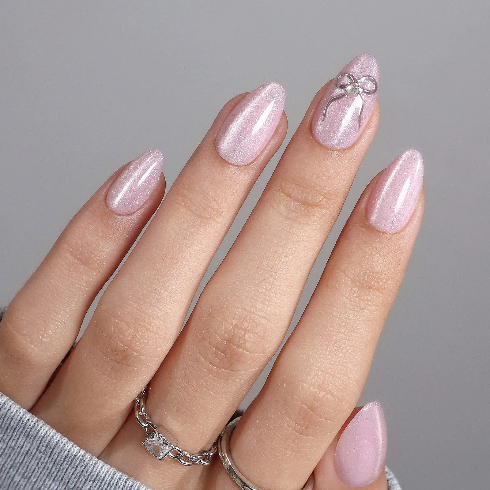 Pale Pink Shimmer Stilettos with Silver Bow Charm Pale Pink Shimmer Stilettos with Silver Bow Charm — Bow Stiletto Nails 2027