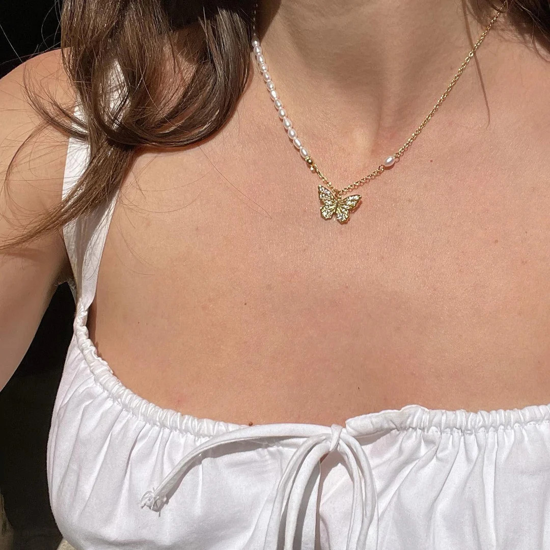 White Tie-Front Top Styled with Pearl and Butterfly Charm Necklace White Tie-Front Top Styled with Pearl and Butterfly Charm Necklace — Locket Necklaces 2027