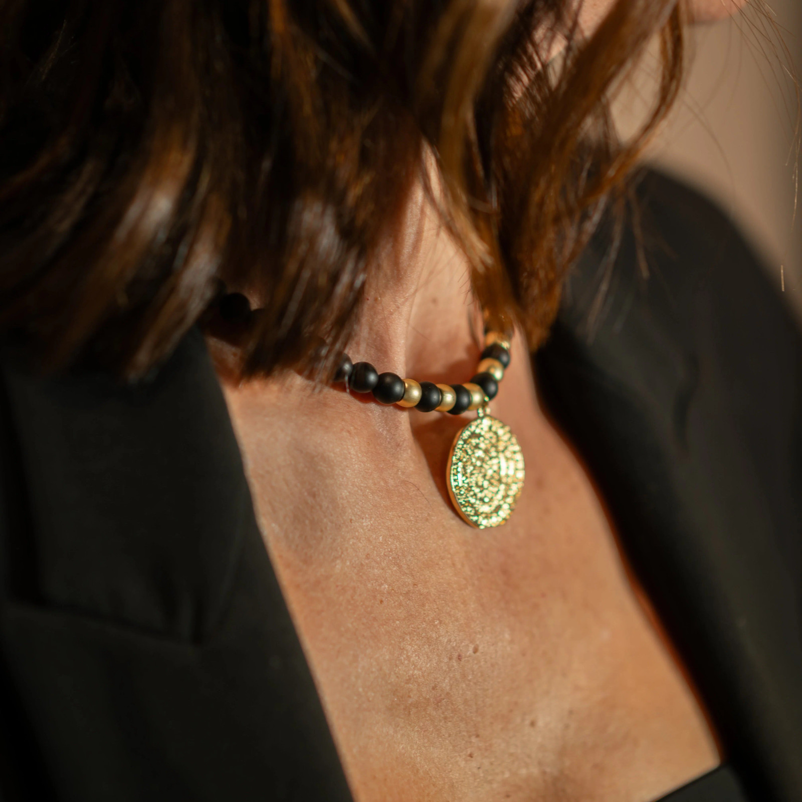 Black Blazer Worn Over an Ornate Medallion with Black Beads Black Blazer Worn Over an Ornate Medallion with Black Beads — Locket Necklaces 2027