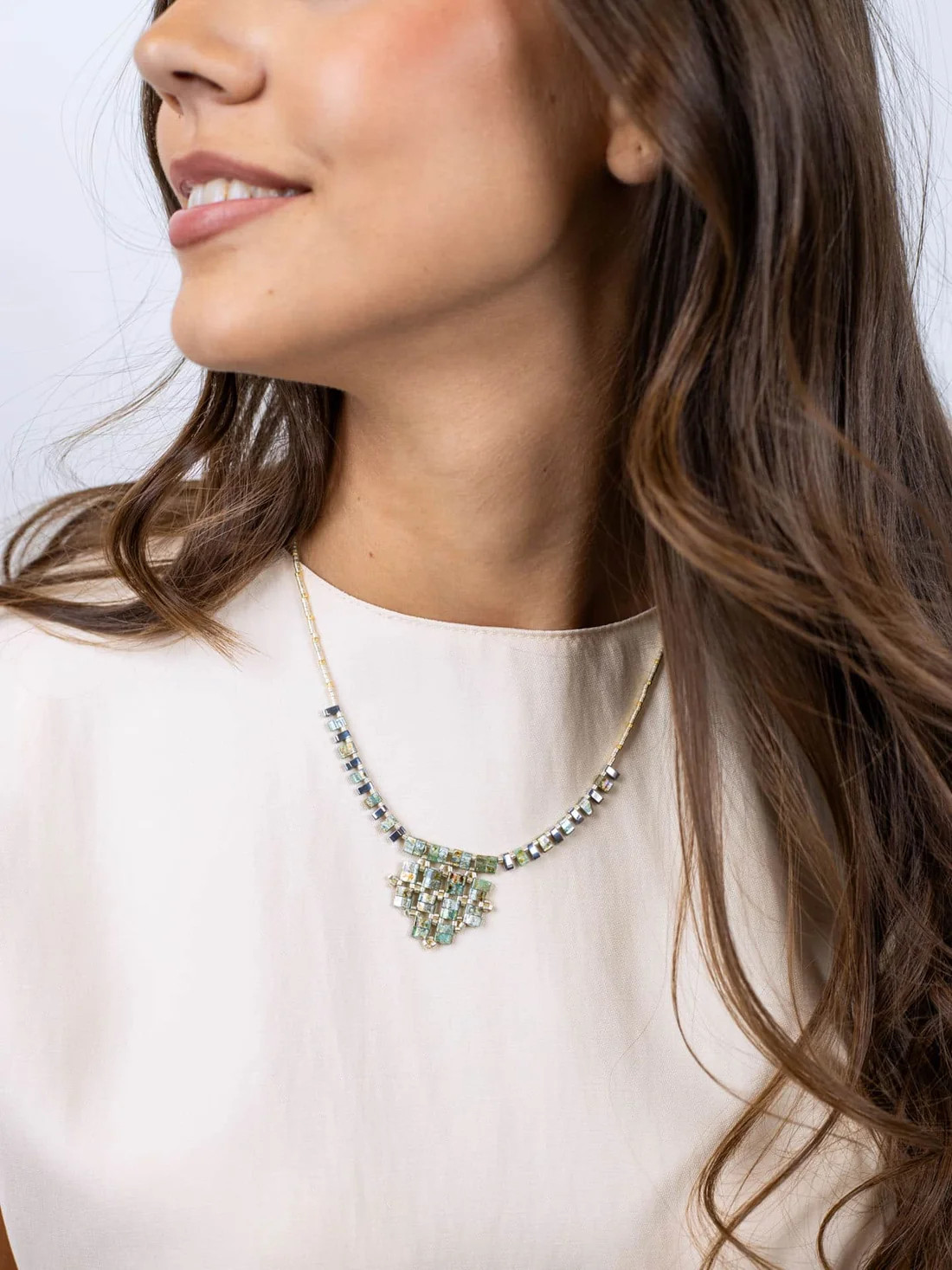 Beige Top Accompanied by a Geometric Multi-Gemstone Pendant Beige Top Accompanied by a Geometric Multi-Gemstone Pendant — Locket Necklaces 2027