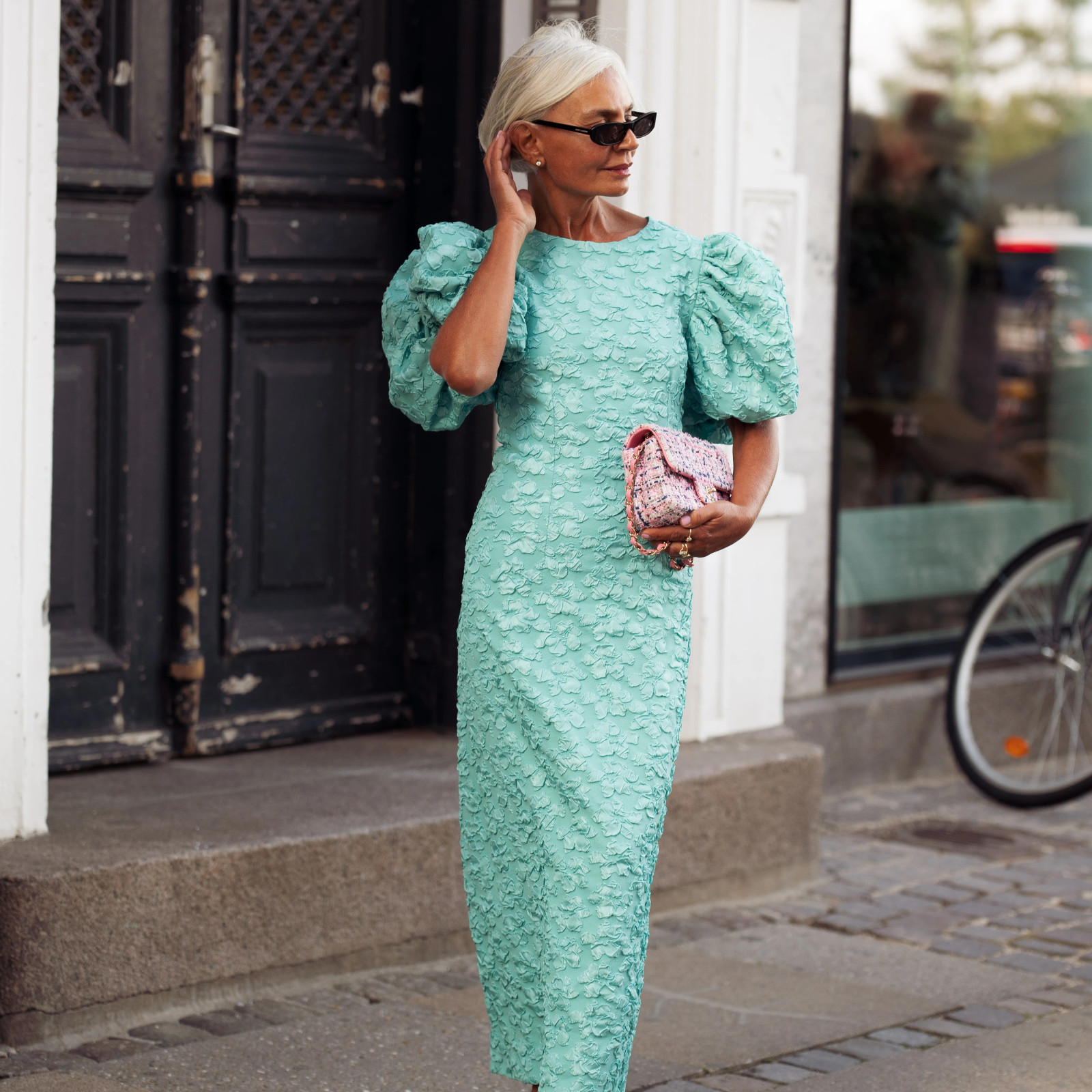 Textured Aqua Midi Dress with Puffed Sleeves and Tweed Handbag Textured Aqua Midi Dress with Puffed Sleeves and Tweed Handbag — Wedding Guest Outfits 2027 for Women Over 50