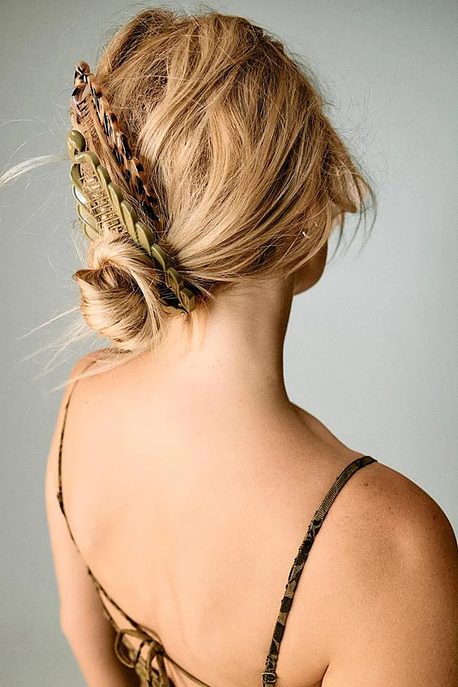 Low Bun With Decorative Clip — Hiking Hairstyles 2027