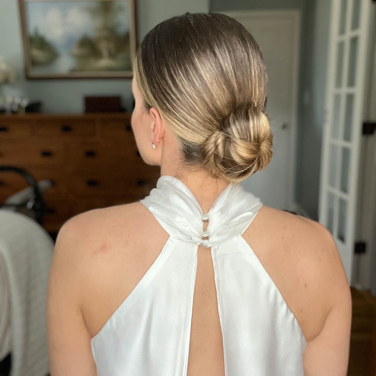 Sleek Chin-Length Bob Low Bun Sleek Chin-Length Bob Low Bun — Prom Hair 2027 for Halter Dress