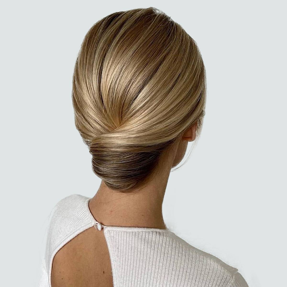 Sleek Blonde Low Bun With Highlights Sleek Blonde Low Bun With Highlights — Quick Quinceanera Hairstyles 2027