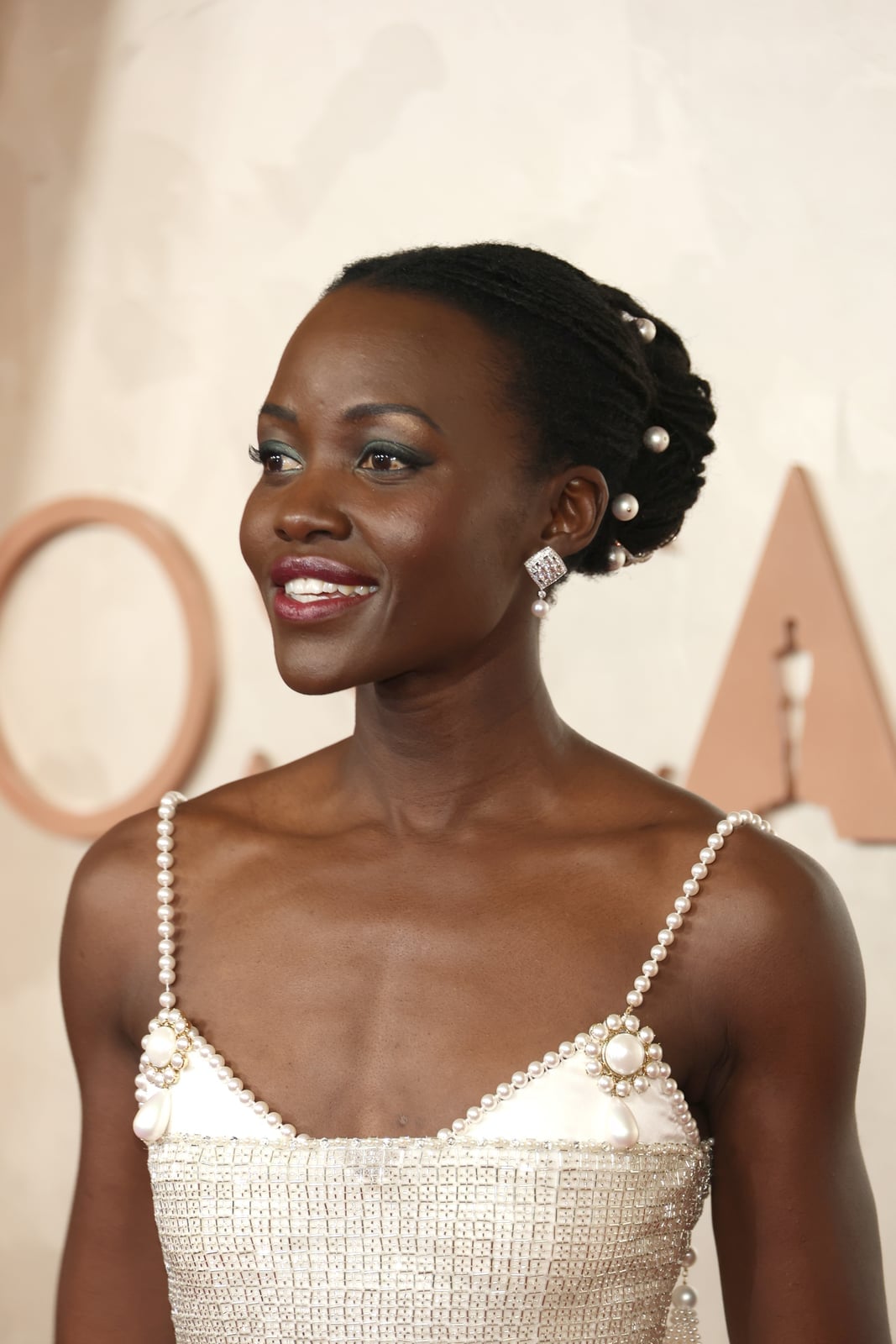 Thick Coily Black Hair In Two Buns With Pearls Thick Coily Black Hair In Two Buns With Pearls — Red Carpet Hairstyles 2027
