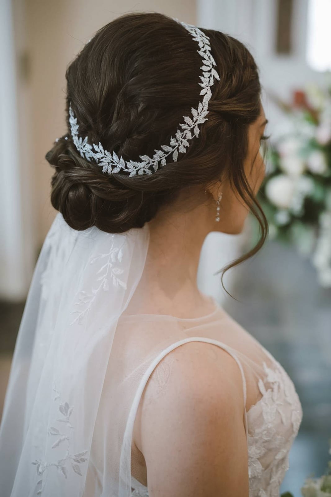 Neck Length Dark Brown Low Bun With Braided Accents Neck Length Dark Brown Low Bun With Braided Accents — Rustic Wedding Hairstyles 2027