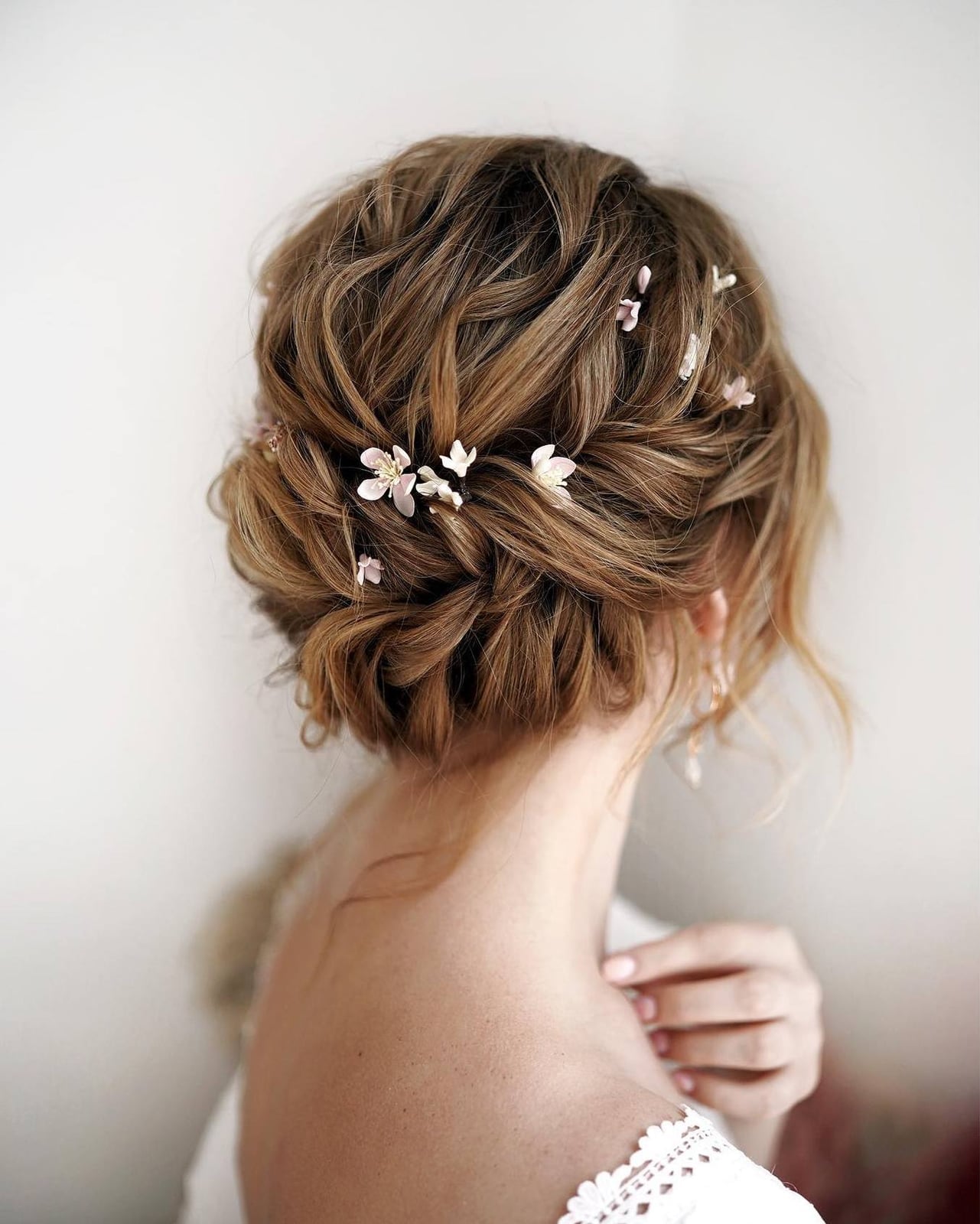 Light Blonde Messy Updo With Braided Elements and Flowers Light Blonde Messy Updo With Braided Elements and Flowers — Rustic Wedding Hairstyles 2027