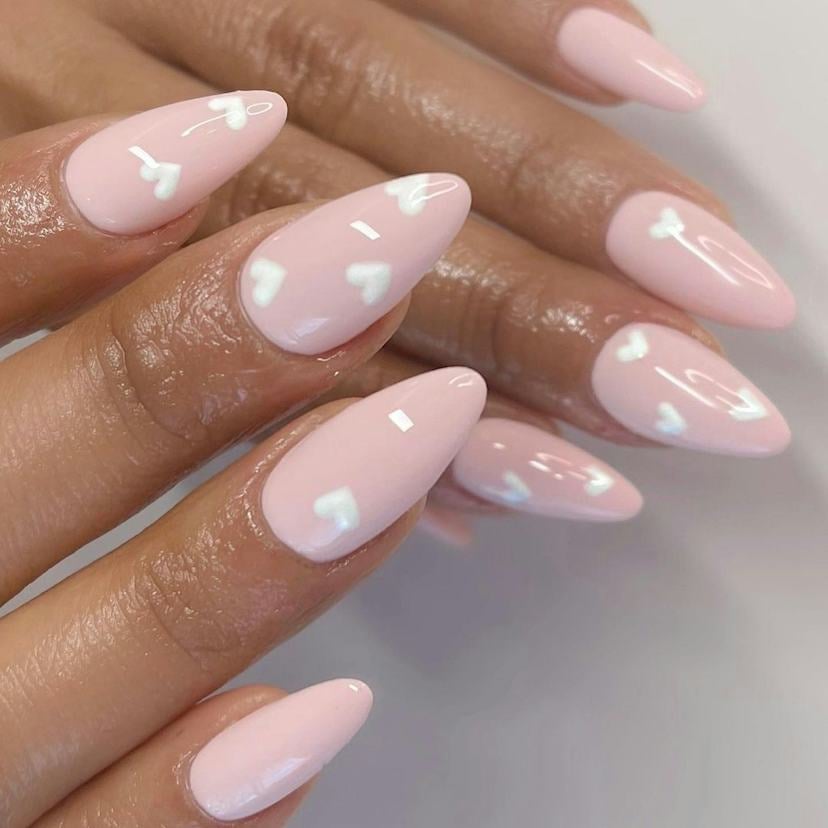 Medium Almond Nails Pale Pink With Scattered White Hearts Medium Almond Nails Pale Pink With Scattered White Hearts — Short Heart Oval Nails 2027