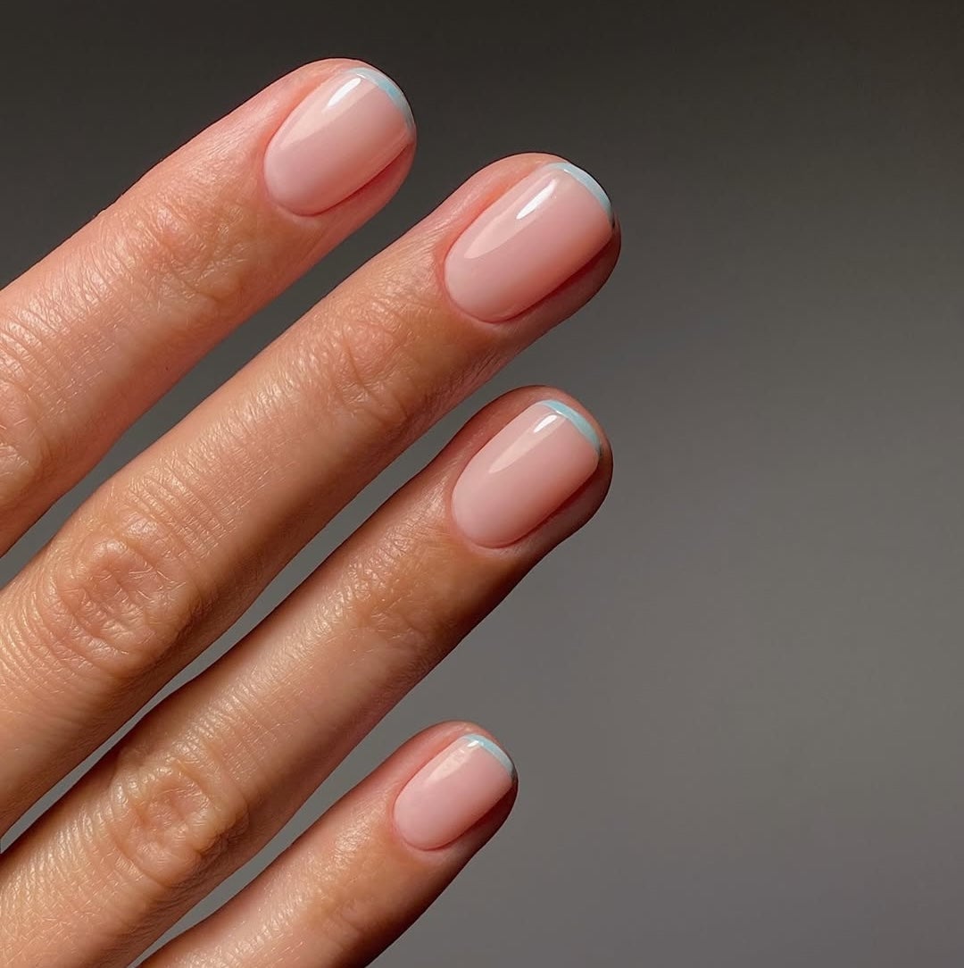 Sheer Nude With Light Blue French Tips Sheer Nude With Light Blue French Tips — Short Nails 2027 for Mature Hands