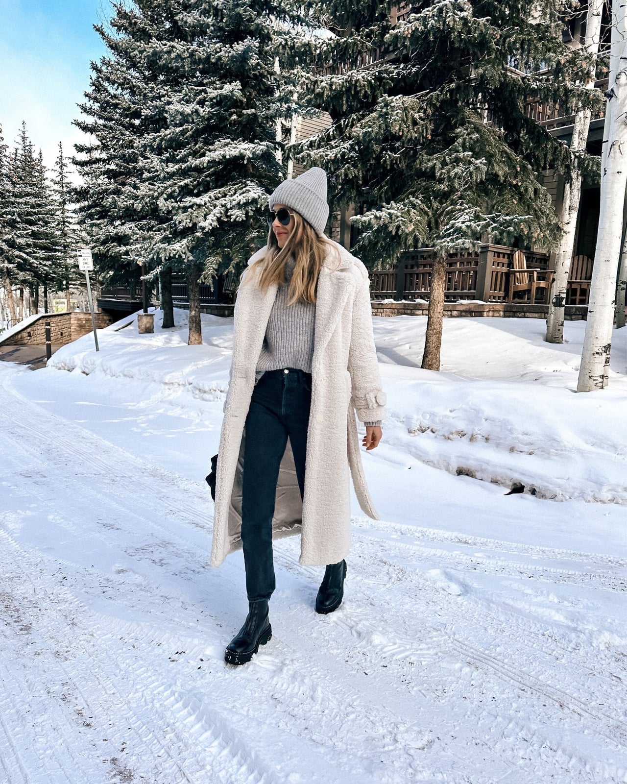 Long cream teddy coat over gray sweater and jeans Long cream teddy coat over gray sweater and jeans — Ski Trip Outfits 2027
