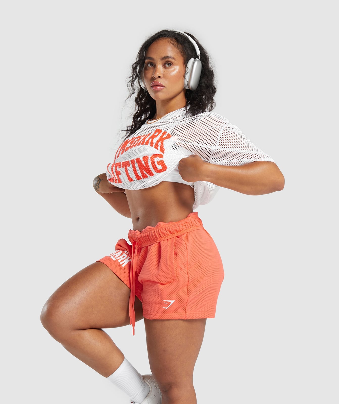 Coral athletic shorts with white mesh top Coral athletic shorts with white mesh top — Sporty Athletic Outfits 2027