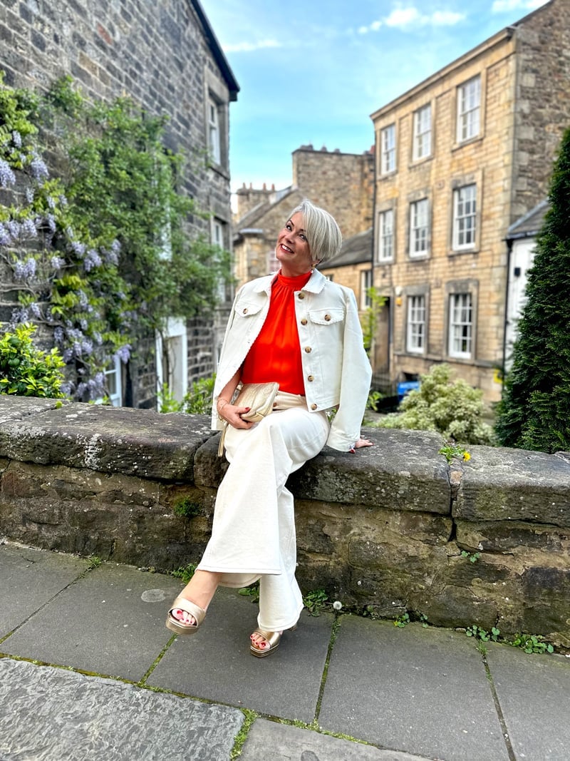 Cream wide-leg trousers with bright orange top for spring Cream wide-leg trousers with bright orange top for spring — Spring Break Night Outfits 2027
